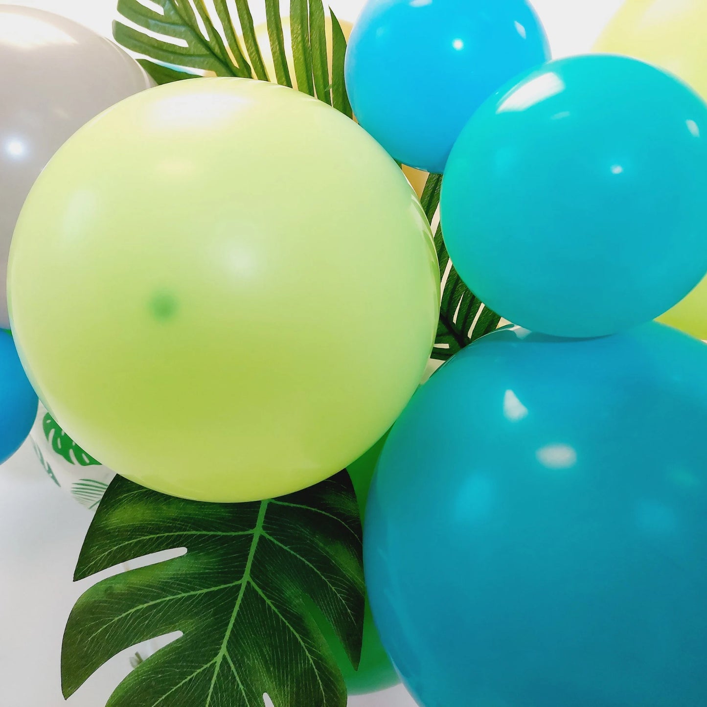 Green and blue dinosaur balloon garland